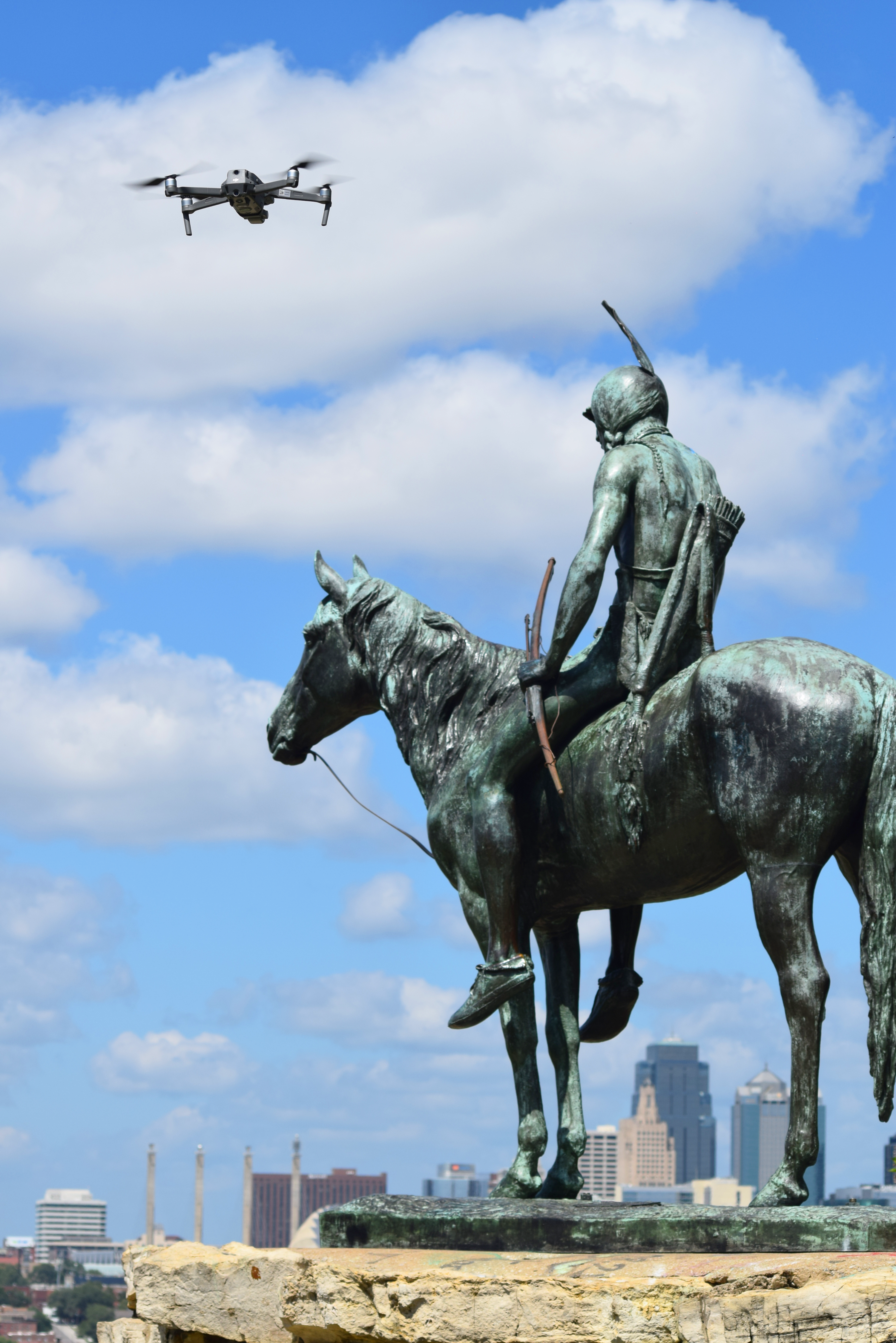 Drone flying next to the Kansas City Scout sculpture