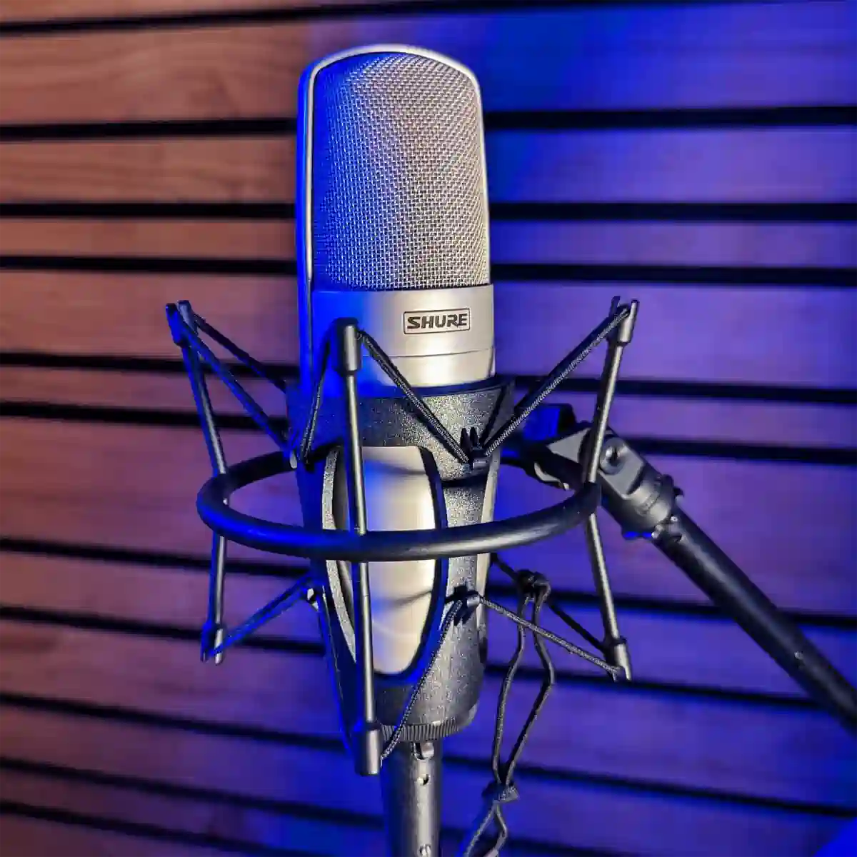 Shure KSM-32 studio large diaphram microphone with blue lighting used for video production and studio recording by Outpost Worldwide.